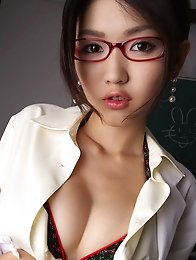 Sexy asian secretary in fish net stockings shows off her boobs